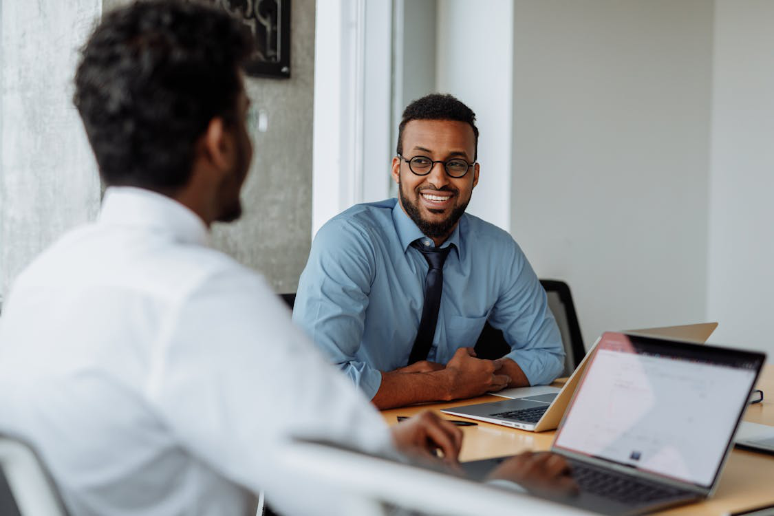  A hiring manager explaining company benefits and growth opportunities to a candidate.