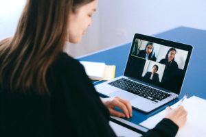 A group of recruiters conducting a virtual interview using a video-calling software program.